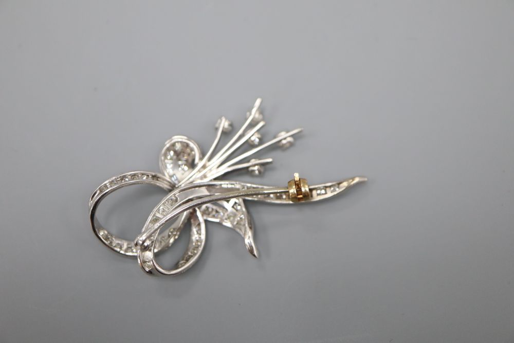 An 18ct white gold? and diamond scroll and spray brooch, 4.5cm, gross 7.8 grams